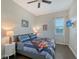 Well-lit bedroom featuring a ceiling fan, a television, and a view from the window at 520 Rye Ne Rd, Bradenton, FL 34212