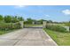 Gated driveway entrance with stone pillars and lush landscaping at 520 Rye Ne Rd, Bradenton, FL 34212