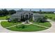 Stunning home featuring a well-manicured lawn, circular driveway, and elegant fountain centerpiece at 520 Rye Ne Rd, Bradenton, FL 34212