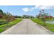 Long driveway leads up to the home with lush landscaping and beautiful trees at 520 Rye Ne Rd, Bradenton, FL 34212