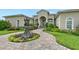 Exterior front of home with a large fountain, beautiful landscaping, and a walkway at 520 Rye Ne Rd, Bradenton, FL 34212