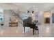 Bright foyer showcasing a grand piano, elegant staircase, and soaring ceilings at 520 Rye Ne Rd, Bradenton, FL 34212