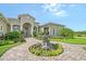 Beautiful home featuring an elegant water fountain and a well-manicured garden leading to the front entrance at 520 Rye Ne Rd, Bradenton, FL 34212