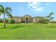 Stunning single story home featuring a circular driveway, fountain, and tropical landscaping at 520 Rye Ne Rd, Bradenton, FL 34212