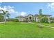 Beautiful one-story home with a circular driveway, decorative fountain, and lush lawn at 520 Rye Ne Rd, Bradenton, FL 34212
