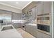 Stylish kitchen boasts stainless steel appliances, sleek gray cabinetry, and a stone backsplash at 520 Rye Ne Rd, Bradenton, FL 34212