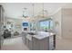 Gourmet kitchen featuring an island with a stainless sink and a living area in the background at 520 Rye Ne Rd, Bradenton, FL 34212