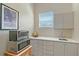 Charming kitchenette featuring a sink, white countertops, cabinets, and microwave on a wooden table at 520 Rye Ne Rd, Bradenton, FL 34212