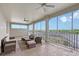 Covered lanai with tile flooring, ceiling fans, and outdoor furniture providing a comfortable seating area with views at 520 Rye Ne Rd, Bradenton, FL 34212