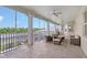 Spacious screened lanai with ceiling fans, tile floors, and comfortable seating overlooking the backyard at 520 Rye Ne Rd, Bradenton, FL 34212
