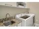 Laundry room with granite countertops, stainless steel sink, and Samsung washer and dryer at 520 Rye Ne Rd, Bradenton, FL 34212