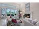 Cozy living room featuring a fireplace, plush seating, and sliding glass doors to an outdoor living space at 520 Rye Ne Rd, Bradenton, FL 34212