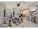 Bright living room featuring neutral tones, a grand staircase, and views into the dining and living areas at 520 Rye Ne Rd, Bradenton, FL 34212