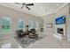Comfortable living area with large windows, a fireplace, and cozy seating arrangement at 520 Rye Ne Rd, Bradenton, FL 34212