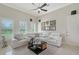 Bright living area with white sectional, ceiling fan, and natural light at 520 Rye Ne Rd, Bradenton, FL 34212