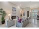 Spacious living room with a fireplace, neutral decor, and large windows for natural light and exterior views at 520 Rye Ne Rd, Bradenton, FL 34212