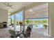 Outdoor patio offers a ceiling fan, in-ground pool, a grill, and table with seating at 520 Rye Ne Rd, Bradenton, FL 34212