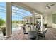 Outdoor patio features a screened enclosure, in-ground pool, ceiling fans, and a table with seating at 520 Rye Ne Rd, Bradenton, FL 34212