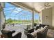 Covered outdoor patio has a screened enclosure, ceiling fan, a seating area, and a pool at 520 Rye Ne Rd, Bradenton, FL 34212