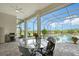 Outdoor patio with screened enclosure features a pool, ceiling fan, grill, and table with seating at 520 Rye Ne Rd, Bradenton, FL 34212
