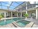 Stunning screened pool and spa area with brick-paved patio and beautiful outdoor living space at 520 Rye Ne Rd, Bradenton, FL 34212