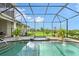 Inviting screened-in pool and spa with brick-paved patio and beautifully landscaped surroundings at 520 Rye Ne Rd, Bradenton, FL 34212