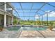 Screened-in pool with spa, brick patio, water features, and picturesque views of the property at 520 Rye Ne Rd, Bradenton, FL 34212