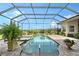 Sparkling screened-in pool and spa surrounded by lush landscaping and a brick-paved patio at 520 Rye Ne Rd, Bradenton, FL 34212