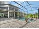 Screened pool and spa with expansive brick patio, lush landscaping, and outdoor entertainment space at 520 Rye Ne Rd, Bradenton, FL 34212