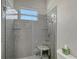 Bathroom shower with glass doors, gray subway tile, shower head, and a small stool at 520 Rye Ne Rd, Bradenton, FL 34212