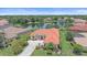 Beautiful lake view home with a red tile roof and mature landscaping in a desirable neighborhood at 5523 Secluded Oaks Way, Sarasota, FL 34233