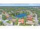 Gorgeous aerial view of homes with red tile roofs and sparkling blue lake at 5523 Secluded Oaks Way, Sarasota, FL 34233