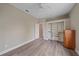 Bedroom featuring hardwood floors, a built-in closet, and a neutral color palette at 5523 Secluded Oaks Way, Sarasota, FL 34233