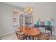 Dining room featuring wood table, elegant chandelier, and lots of natural light at 5523 Secluded Oaks Way, Sarasota, FL 34233