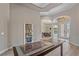 Inviting foyer featuring decorative arches, tiled floors, and access to the dining room at 5523 Secluded Oaks Way, Sarasota, FL 34233
