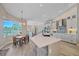 Open-concept kitchen featuring an island, breakfast nook, stainless steel appliances, and plenty of cabinet space at 5523 Secluded Oaks Way, Sarasota, FL 34233