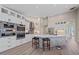 Modern kitchen features stainless steel appliances, an island with counter seating, and white cabinets at 5523 Secluded Oaks Way, Sarasota, FL 34233
