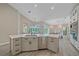 Spacious open kitchen featuring a large island, stainless steel appliances, ample counter space, and eat in breakfast nook at 5523 Secluded Oaks Way, Sarasota, FL 34233