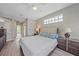 The main bedroom featuring a ceiling fan, light walls and decorative window above the headboard at 5523 Secluded Oaks Way, Sarasota, FL 34233