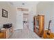 Bright office features wood-look flooring, built-in shelves, glass door cabinet and an open door leading to another room at 5523 Secluded Oaks Way, Sarasota, FL 34233