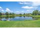 The community's serene pond creates a tranquil neighborhood ambience, perfect for peaceful living at 5523 Secluded Oaks Way, Sarasota, FL 34233