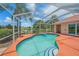 Relaxing enclosed pool area with a scenic backyard, blending comfort with outdoor charm at 5523 Secluded Oaks Way, Sarasota, FL 34233