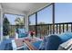 Cozy balcony with comfortable seating, a table, flowers, and a serene outdoor ambiance at 5600 Beach Way Dr # 315, Sarasota, FL 34242