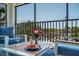Balcony with seating, flowers, and a table with a bottle of wine, perfect for relaxing outdoors at 5600 Beach Way Dr # 315, Sarasota, FL 34242