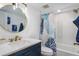 Beautiful bathroom featuring a vanity with modern fixtures and decorative shower curtain at 5600 Beach Way Dr # 315, Sarasota, FL 34242