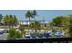 Picturesque beach view framed by palm trees and overlooking a lively beachside scene at 5600 Beach Way Dr # 315, Sarasota, FL 34242