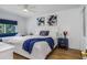 Cozy bedroom featuring a comfortable bed with blue accents and natural light at 5600 Beach Way Dr # 315, Sarasota, FL 34242