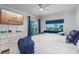 Bright bedroom featuring a full bed, balcony access, and a modern dresser at 5600 Beach Way Dr # 315, Sarasota, FL 34242