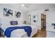 Comfortable bedroom featuring a queen bed and a walk-in closet for storage at 5600 Beach Way Dr # 315, Sarasota, FL 34242