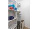 Bright closet with a laundry bin and shelves to keep towels and linens organized at 5600 Beach Way Dr # 315, Sarasota, FL 34242